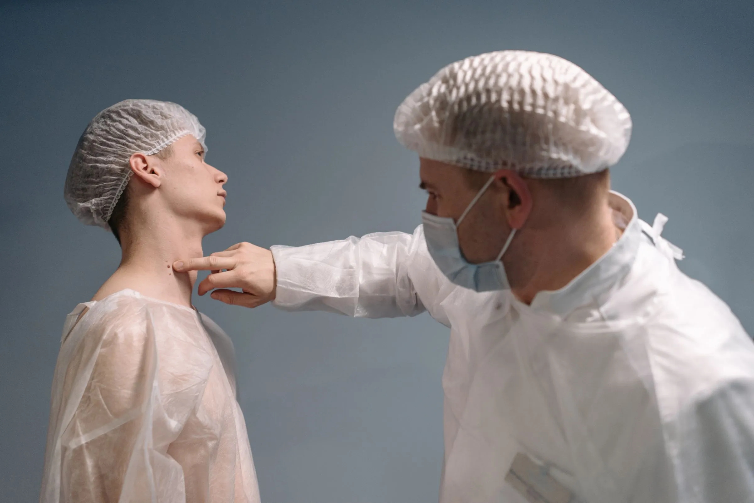 A clinician examining a patient's skin during a screening appointment